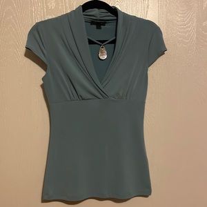 Blouse with attached necklace.